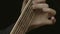 Closeup of man\'s hands playing acoustic guitar