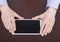 Closeup of man\'s hands with tablet computer.