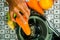 Closeup man\'s hands using juice maker, inserting carrot into machine, healthy lifestyle concept