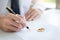 Closeup of a man Signing Contract or premarital agreement, filling petition form agreement of divorce in office at lawyer desk in