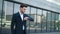 Closeup man standing near business building. Businessman waiting in suit outdoor