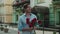 Closeup man throwing red roses at paved street. Man smelling roses at street