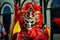 Closeup man in vivid carnival costume poses for photo on dominican city street