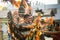 Closeup man in vivid carnival costume walks under rain on dominican city street