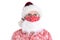 Closeup of a man wearing a Hawaiian Shirt,Santa Claus hat and COVID-19 mask with beard attached. Isolated on white