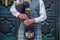 Closeup of a man wearing Scottish kilt and holding bagpipe wind musical instrument