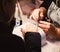 Closeup manicurist applies nail gel polish