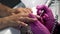 Closeup of manicurist removes gel shellac polish from client`s nails using manicure machine