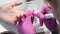 Closeup of manicurist removes gel shellac polish from client`s nails using manicure machine.