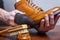 Closeup of Mans Hands with Cleaning Cloth Used for Polishing and Creaming Tan High Derby Boots