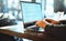 Closeup mans hands freelancer sitting in cafe working laptop