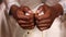 Closeup of mans hands while praying