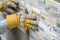 Closeup of manual worker in protection gloves pushing the tile i