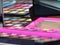 Closeup of many colorful makeup palettes with mirrors on a table