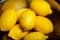 closeup many juicy lemons lie in metal bowl