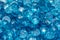 Closeup of many small blue zircon gemstones. Bright luxury background