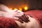 Closeup of the massage therapist physiotherapist`s hand on the stomach of a woman client in a massage parlor. The