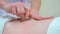 Closeup masseur hands doing anti cellulite massage with vacuum cups on abdomen