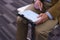 Closeup of mature hands holding tablet.