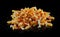 Closeup of mayonnaise and ketchup on pile of appetizing crinkle cut French fries on a black table