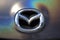 Closeup of Mazda Motor Corporation brand logo. Chrome car emblem sign. Tuning Show, Tomsk, Russia 2019-06-15