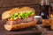 Closeup meat sandwich, potatoes and cola on wooden background