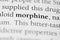 Closeup of the medical or addictive pharmacology term 'Morphine' in black on white paper