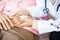 Closeup medical female doctor or nurse holding senior patient hands and comforting her at hospital bed,hand of elderly woman with