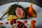 Closeup medium raw meat in dill decorated with carrot and viburnum berries