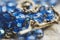 Closeup of a metal cross with jesus blue glass rosary