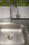 Closeup of the metal sinks with the chrome tap after washing