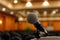 closeup of a microphone on a podium in a seminar room