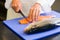 Closeup mid section of a chef cutting fish