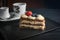 Closeup of a Mille-feuille cake with berries and a cup of coffee