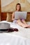 Closeup of millennial woman accessories on luxurious hotel bed w