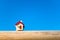 Closeup miniature house on blue sky background using as property