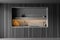 Closeup of minimalist dark kitchen cabinet with grey granite niche