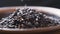Closeup mix. Brown rice, Black Jasmine rice, and Rice berry in bowl in dark wooden bowl on the wood black