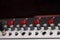 Closeup mixing faders and knobs as seen from above side angle, artistic studio equipment concept