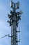Closeup of mobile telecommunication tower or cell tower with antennae and electronic communications equipment