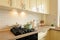 Closeup of modern cream colored kitchen interior