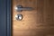 Closeup modern door handle with keyhole on wooden door