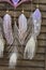 Closeup modern dreamcatcher star mandala with amethyst and peacock feathers on wooden background