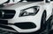 Closeup modern luxury white front lights headlight and head lamp rims of powerful sport car. Dealership office showroom sale hype