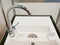 Closeup of modern square kitchen sink with two faucets