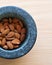 A closeup of a mortar full of almonds