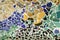 Closeup of mosaic of colored ceramic tile by Antoni Gaudi at his Parc Guell, Barcelona, Spain