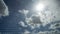 Closeup of mosquito wire screen with sun ray on blue sky and white clouds in background