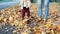 Closeup mother with baby walking by autumn leaves outdoor