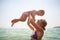 closeup mother teaches swim small daughter in azure sea